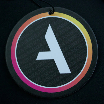 Round black air freshener with a white letter 'A' on a dark background