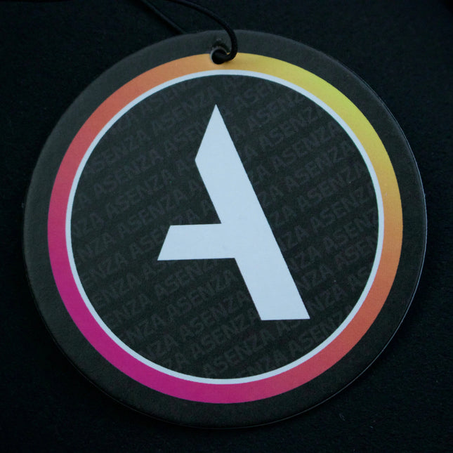 Round black air freshener with a white letter 'A' on a dark background