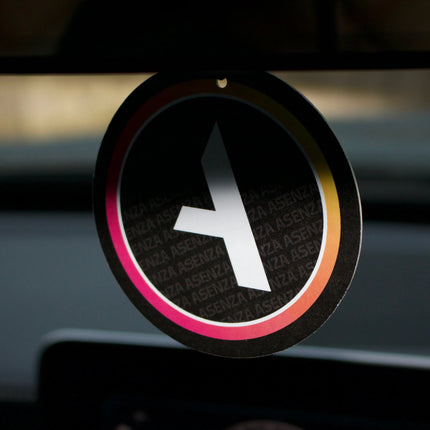Car air freshener with a logo on a car dashboard