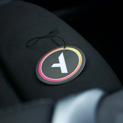 Car air freshener with a logo on a car seat