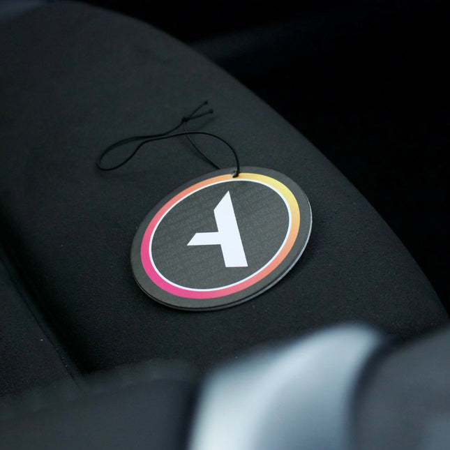 Car air freshener with a logo on a car seat